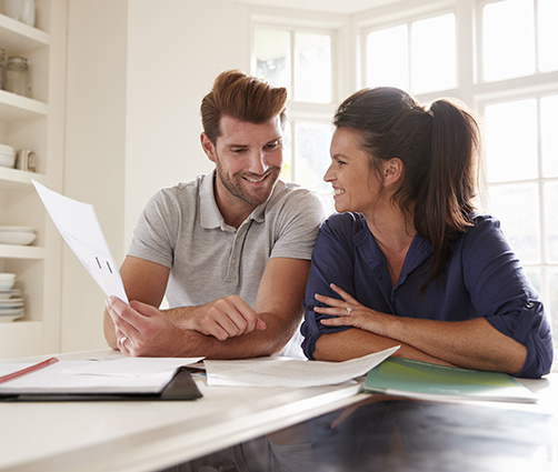 Couple Smiling at Computer