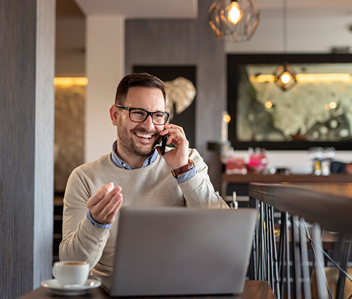 Guy Sitting At A Table Having Coffee